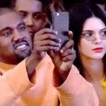 Kanye taking a picture