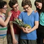 4 young men and a pineapple