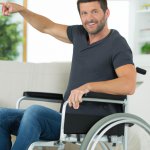 man pointing at wheelchair