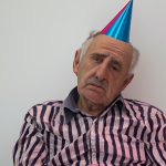 a old man sad old man with a party hat on his head