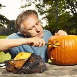 Older Man Carving Helloween Pumpkin For Upcoming Holiday Event S