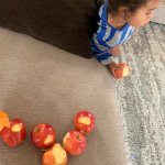 Kid taking bite from all apples