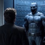 Batman looking at suit