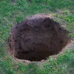 Deep Dirt Hole In Ground Or Lawn Stock Photo - Download Image No