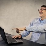 man computer laughing