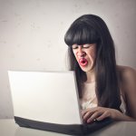 Girl crying on her computer