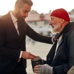 Man giving money to homeless person