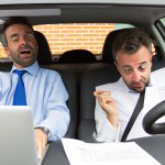employee completely overwhelmed with work, while the boss drives