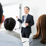 business man teaching a class