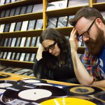 a couple of record store music nerds in contemplation