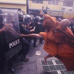 Monk kicking riot police