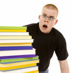 A student staring at a mountain of textbooks with a perplexed ex