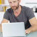 A man working from home on a laptop template