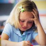 LITTLE GIRL CRYING OVER SCHOOLWORK