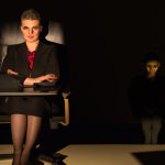 Female Boss sitting in a dark Office and one little person stays