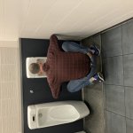 Bending down at urinal