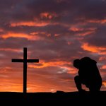 Kneeling before the cross
