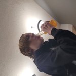 Greasy receding hairline teen drinking orange soda