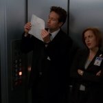 Mulder and Scully Elevator Looking At Paper