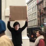Javier Milei holding a cardboard sign