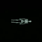 Skeleton lying in a dark background