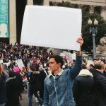 Guy Holding Protest Sign [No WM]