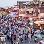 A picture of a bustling marketplace with various vendors and sho