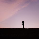 Young woman’s silhouette looking into distance