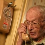 Old man on rotary telephone