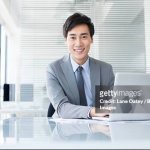 Asian guy on desk