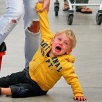 kid on floor in supermarket