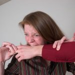 Woman biting man