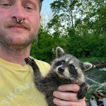 Man holding raccoon