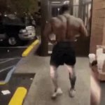 Muscular guy walks in store GIF Template