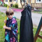 kid holding a crowbar about to hit a Punching Bag