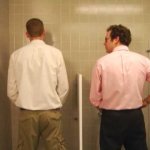 Guy staring at urinal