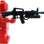 red Lego-minifig welding an M16A2 with M203