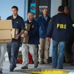 FBI agents with boxes