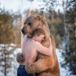 man hugging bear