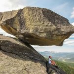 Woman under rock