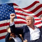 Uncle Trump fist pump with old glory standing tall behind him.