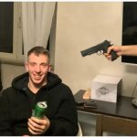 Happy man with a gun pointed at him