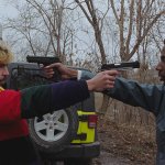 Two guys pointing a gun at each other