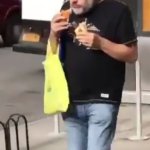 Zizek eating two hot dogs