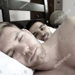 Two men in bed together