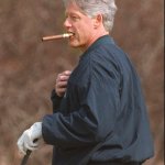 Bill Clinton smoking a cigar while playing golf