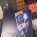 Joker holding the Blue Eyes White Dragon card