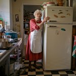 Grandma hanging to a fridge freezer