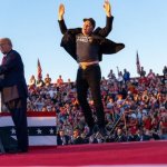 Elon Musk jumping at Donald Trump rally