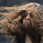 Longhaireded man with wind blowing hair forward